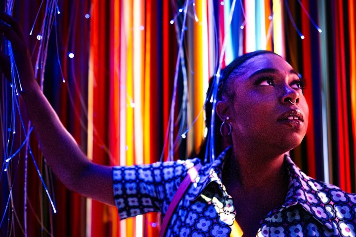 a man standing on a stage in front of a curtain