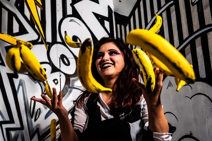 a person holding a banana
